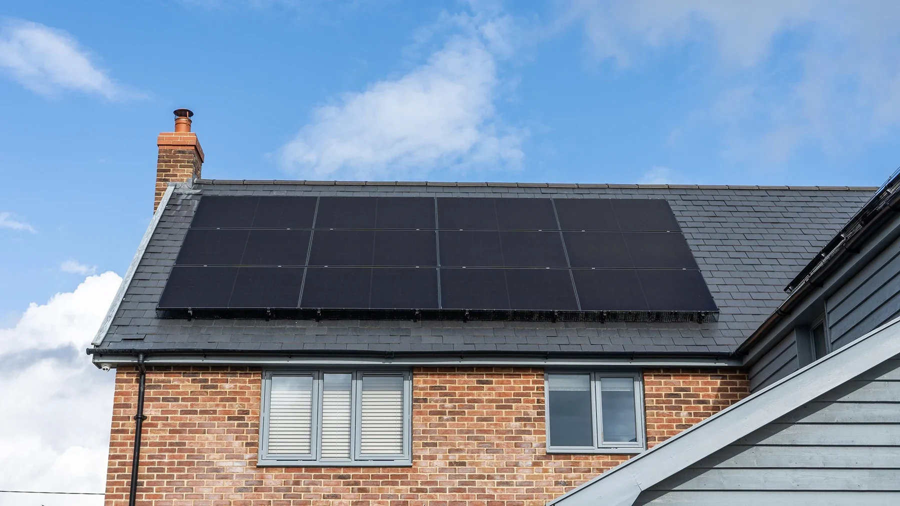 Real black solar panel installation on a UK slate roof